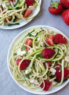 This Strawberry Zucchini Noodle Salad comes together in less than 10 minutes and makes a healthy, easy, and gluten free summertime dish - Eat the Gains