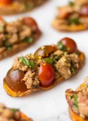A paleo and Whole30 approved protein packed, this Tuna Bruschetta on Sweet Potato Toast makes easy, healthy, and crowd pleasing appetizer or snack! - Eat the Gains