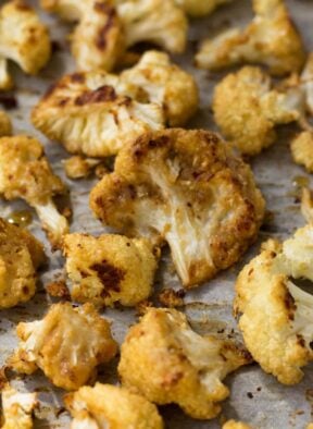 This vegan and paleo Maple Tahini Roasted Cauliflower make for an easy sweet and savory side dish - Eat the Gains