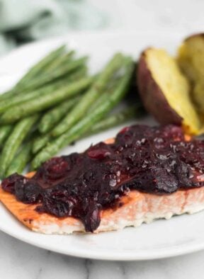 An easy and festive seafood dish, this Cranberry Balsamic Roasted Salmon takes 15 minutes and is a crowd pleaser for the holidays - paleo, gluten free, and Whole30 approved! - Eat the Gain