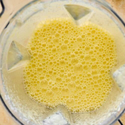 A blender with homemade mango milk in it.