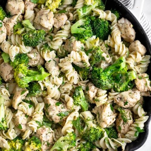 Pan filled with chicken ranch pasta with broccoli and lots of herbs.
