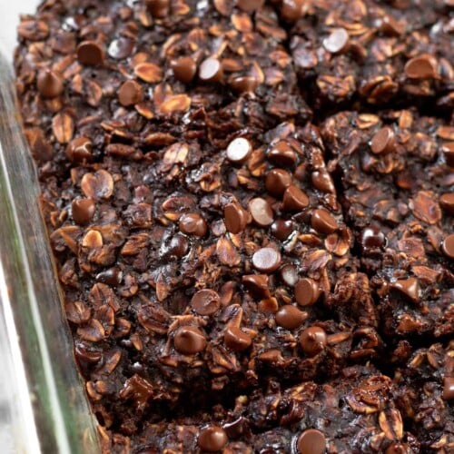 Close up of brownie baked oatmeal in a baking dish cut into squares.