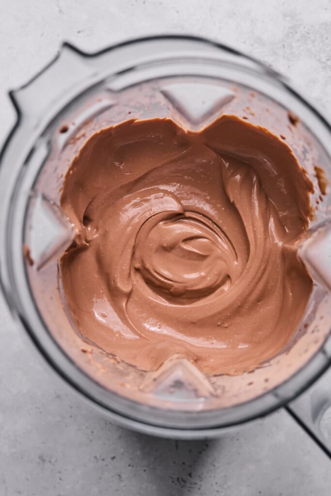 Blender filled with chocolate protein pudding.