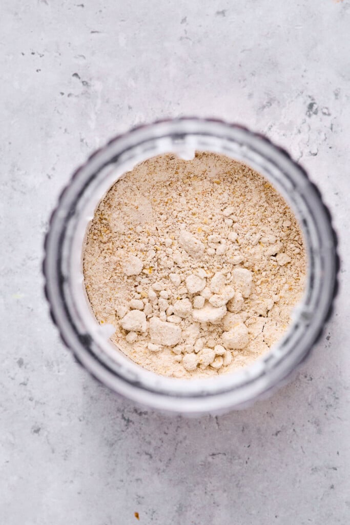 Small jar blender filled with oat flour that has just been blended.