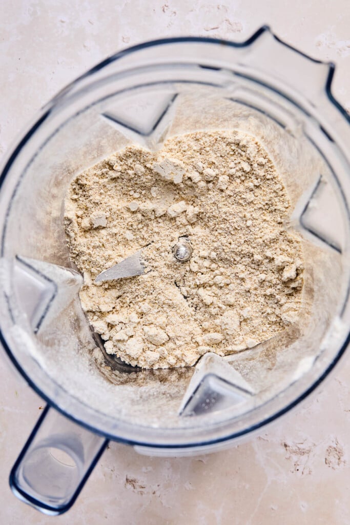 Blender filled with oat flour that has just been blended.