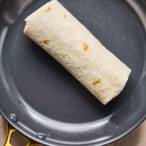 Sandwich wrap in a skillet.