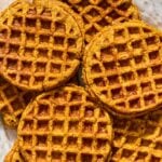 A plate with a bunch of pumpkin waffles spread on it.